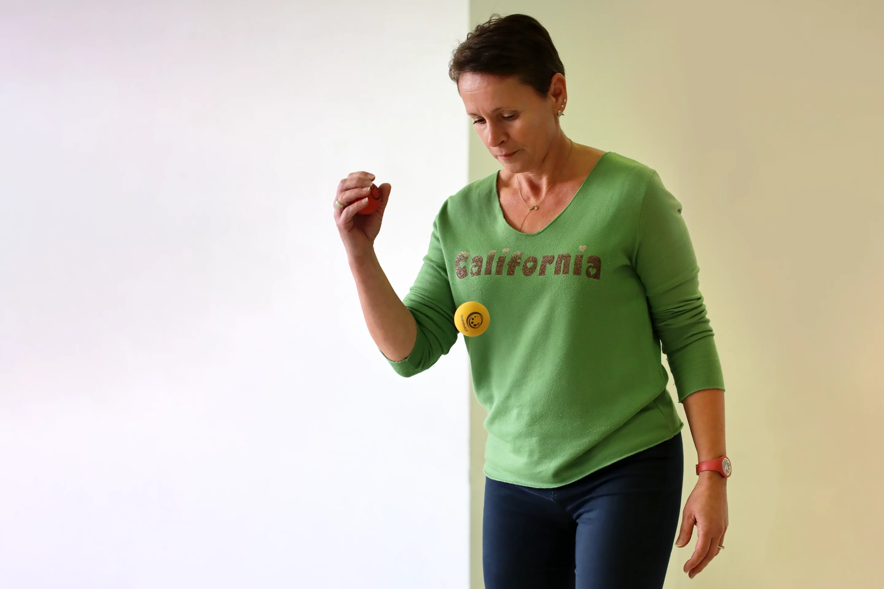 Adulte réalisant un exercice Brain Ball® de coordination œil-main avec une balle, pour favoriser le retour à l’attention après un épisode de vagabondage mental.